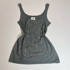 Brand New With Tag Beautiful Vintage Abercrombie And Fitch Dark Gray Tank Top Featuring The Most Amazing Floral Beaded Design! Size:Small More On The S/M Side Dimensions Aprox Pit To Pit:15 Length:26 Open To Offers! Silver Summer Top With Rhinestones, Silver Rhinestone Tops For Summer, Embellished Silver Summer Top, Spring Silver Embellished Top, Vintage Abercrombie And Fitch, Thrift Inspo, Vintage Abercrombie, Gray Tank Top, Grey Tank Top