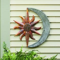 Place a heavenly adornment on your wall using the Ancient Graffiti Metal Celestial Wall Art. The full sun and crescent moon shape on this item brings a familiar motif to your wall, and its bold colors will surely enhance any setting. Slightly overlapping and creased sun rays emanate from a center disc, with raised spheres and a face here for dimension and personality on the piece. The varying copper hues on the sun shape lend a warm hint to it, while remaining true to the theme. A crescent shape Moon Wall Hanging, Building A Pergola, Rain Chain, Walled Garden, Garden Wall Art, Easy Garden, Outdoor Wall Decor, Garden Cottage, Sun And Moon