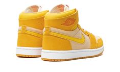 The Women’s Air Jordan 1 Zoom Comfort 2 “Sunshine” is a women’s-exclusive colorway of the lifestyle shoe with an eye-grabbing color block.  The Jordan 1 Zoom Comfort 2 is the second edition of the modified version of Michael Jordan’s first signature shoe that features Zoom Air cushioning technology, and other design updates.  On this colorway, the shoe has Yellow Ochre and Tour Yellow suede overlays on a Pale Vanilla base.  A cut-out yellow Swoosh appears on the sides, while a Safety Orange “Win Air Jordan 1 Zoom Comfort, Yellow Ochre, Stadium Goods, Safety Shoes, Michael Jordan, Air Jordan 1, Jordan Shoes, Jordan 1, Air Jordan