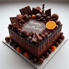 a birthday cake with chocolate and oranges on it