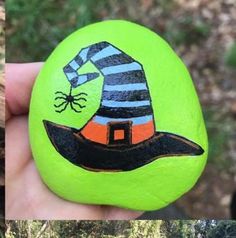 two pictures of painted rocks with witches hats on them, one is green and the other is black