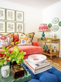 a living room filled with lots of furniture and flowers on top of a coffee table