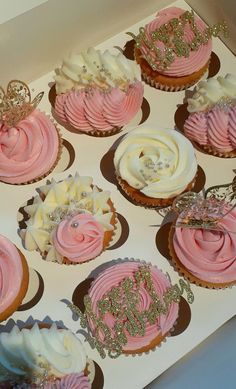 cupcakes with pink and white frosting in a box