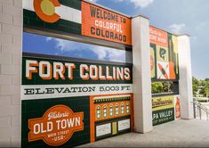 the entrance to fort collins's celebration is painted in orange and green, along with other signs