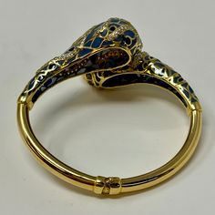 18K Gold Hinged Snake Bracelet with Diamonds and Enamel (includes appraisal, Value: $9,000) Designer = Jewelry Material = 18K Gold Gemstone = Diamond Condition = Very Good Class = Premier Location: Wilmette Item Number: 11750-314 Item ID: 279025 Category: Bracelet Designer Enamel Bangle Jewelry, Luxury Enamel Bangle Bracelets, Luxury Collectible Round Bangle, Luxury Diamond Jeweled Bracelets, Luxury Yellow Gold Enamel Bangle, Luxury Hallmarked Bracelets For Collectors, Luxury Gold Bangle Collectible, Luxury Jeweled Yellow Gold Bracelets, Elegant Enamel Bangle For Formal Occasions