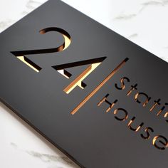 a black sign with gold foil on it that says 24 stradhouse in the center