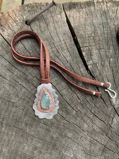 "This unique mixed metals pendant is entirely crafted by hand with primitive metalworking techniques. It features a very high quality aqua chalcedony gemstone with a copper & Sterling silver setting. The copper really makes the gemstone stand out in this piece. This pendant has lots of rustic charm, texture & patina. It is stamped with the Bible verse \"Nahum 1:17\". This would make the perfect inspirational gift for any occasion or as a reminder for oneself to always seek strength throu Artisan Necklace With Adjustable Patina, Artisan Chrysoprase Necklaces For Jewelry Making, Rustic Silver Jewelry With Patina, Nature-inspired Patina Pendant Jewelry, Silver Artisan Necklace With Patina, Artisan Silver Necklace With Patina, Unique Patina Round Pendant Necklace, Southwestern Style Hand Tooled Necklace As Gift, Bohemian Hand Tooled Jewelry For Everyday Use