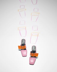 two pairs of pink and orange shoes are hanging on the wall with glasses attached to them