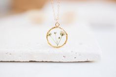 - N E C K L A C E -The small branch of Baby's Breath flower inside the necklace! Flowers protected with crystal resin that helps to retain its nature beauty for a long time. This is a stunning statement piece for any flower lover! Real flowers necklace for mother and daughter, for sisters or bridesmaids gift.The chain length is adjustable! You chose the length!Diameter : 20mm diameterMaterials: Resin / Real flower / silver 925 necklace / silver 925 chain------------------------------------------ Minimalist Hypoallergenic Flower Pendant Jewelry, Hypoallergenic Minimalist Flower Pendant Jewelry, Minimalist Flower Shaped Birthstone Jewelry, Minimalist Flower Necklaces For Bridesmaids, Minimalist Tiny Flower Jewelry, Minimalist Tiny Flower Shaped Jewelry, Nature-inspired Birth Flower Jewelry For Everyday, Delicate Pressed Flowers Jewelry For Everyday, Delicate Hypoallergenic Charm Necklace As Gift For Her