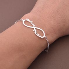 This Personalized Infinity Name Bracelet is one of the most special and personal pieces of jewelry you can own or give as a gift. This Infinity Name Bracelet is made of solid sterling silver. All items are nicely packaged ready to gift in elegant jewelry boxes. Product Description Pendant&Chain:Sterling Silver Color: silver, gold,rose gold,white gold Nameplate Width: 20-30 mm (according to the length of the names,its size is not fixed) Thickness : 1.2 mm. (approx.) ###How to order### Please choo Elegant Nickel-free Name Bracelet For Mother's Day, White Hypoallergenic Name Bracelet For Anniversary, Hypoallergenic White Name Bracelet For Anniversary, Minimalist Name Bracelet For Father's Day Gift, Customizable Sterling Silver Name Bracelet Gift, Personalized Silver Name Bracelet For Anniversary, Sterling Silver Bracelet Jewelry For Birthday, Infinity Jewelry For Birthday, Silver Sterling Name Bracelet For Gift