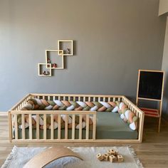 a baby crib in the middle of a room with toys on the floor and walls