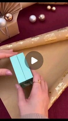 a woman is wrapping presents on a table