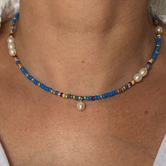 This 14K GF blue seed bead and freshwater pearl necklace is a story of joy near by the water .. Close your eyes... Are you there ? Wear it on its own for a sleek style, or as an accumulation for a more bohemian touch. * Materials :  14K GOLD FILLED clasp and extension chain. Gold-filled  is a thick layer of gold on metal, a higher-quality material than gold-plated. High quality glass seed beads  Natural freshwater selected pearls size about 7x6 mm * Size: The necklace is a choker measuring 39 cm + a 3 cm extension chain. * Customization If you'd like a different length or a particular color, write me a message. I'll be happy to realize your unique design!   * Delivery The parcel is shipped within 1 to 2 days by 📩 TRACKED PARCEL SERVICE 📩 Your jewelry comes in a pretty little velvet pouch Cheap Blue Beaded Necklaces With Tiny Beads, Blue Jewelry With Pearl Charm And Round Beads, Blue Necklaces With Pearl Charm And Round Beads, Blue Necklace With Pearl Charm, Blue Dainty Necklace With Colorful Beads, Dainty Blue Necklace With Colorful Beads, Blue Pearl Beaded Necklaces With Pearl Charm, Blue Pearl Necklaces With Colorful Beads, Adjustable Blue Pearl Necklace With Pearl Charm