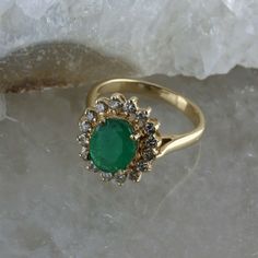 Vintage 14K Yellow Gold Oval Emerald and Diamond Halo Ring, 1.53ct emerald set high 5/16 inches on ring, basket setting, oval emerald 1.53 ct, 9x7mm, .56 ct round diamonds halo (16 total), .5 inches across, Ring size 4.75, Circa 1960, 4 grams. Stock # BB256R04 Most rings are sizable for a small fee. If the ring you are considering is the incorrect size contact us for a quote. This listing contains photographs of the actual item you will receive. Our items are in excellent condition with little o Heirloom Oval Emerald Cluster Ring, Vintage Oval Emerald Ring With Halo Setting, Green Oval Cluster Ring With Hallmark, Oval Green Cluster Ring In 14k Gold, Classic Green Cluster Ring Stamped 14k, Vintage Oval Emerald Ring With Prong Setting, Vintage Oval Emerald Cluster Ring, Ring Basket, Emerald Set