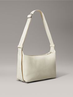 A versatile essential for everyday wear, this shoulder bag is constructed from 100% faux leather for a lustrous finish. Designed with a zip closure at the top and features Calvin Klein logo styling along the straps. Finished with an embossed CK monogram logo design at the front.  Material: 100% Polyurethane. Modern Calvin Klein Shoulder Bag, Casual Calvin Klein Bag With Adjustable Strap, Chic Calvin Klein Shoulder Bag With Adjustable Strap, Calvin Klein Leather Shoulder Bag With Adjustable Strap, Calvin Klein Leather Crossbody Bag, Ck Monogram, Round Shoulder Bag, Monogram Logo Design, Fashion Logo