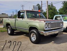 an old pick up truck parked in a parking lot