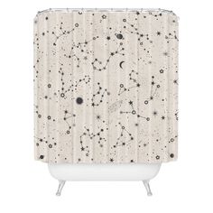 a shower curtain with stars and planets in the sky, on a white bathtub