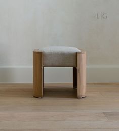 a chair sitting on top of a hard wood floor next to a wall with the word lg written on it