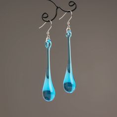 "These Light blue long teardrop dangle earrings are made of glass in lampwork technique. The stainless steel hooks are hypoallergenic. They will not tarnish, fade, or discolor with time. These unique and beautiful earrings are like water drops frozen in glass! They are simple and elegant, very lightweight and comfortable to wear, perfect for everyday wear and for special occasions. You will definitely receive lots of compliments on your new earrings, everybody loves them, and you'll love them to Modern Glass Teardrop Earrings, Modern Long Drop Teardrop Earrings Gift, Elegant Turquoise Drop Teardrop Earrings, Turquoise Teardrop Drop Earrings With Ear Wire, Modern Blue Teardrop Jewelry, Modern Blue Long Drop Earrings, Modern Blue Long Drop Jewelry, Modern Blue Teardrop Earrings, Blue Teardrop Drop Earrings