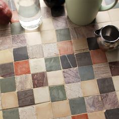 the table is covered with different colored tiles