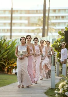 the bridesmaids are walking down the path together