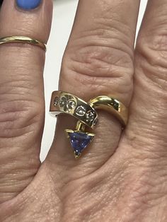 This stunning 18k vintage Le Vian ring features a beautiful 6mm trillion tanzanite stone and 6, (approximately) 5 pt diamonds totaling 1/4 carat. The ring is a size 7 and crafted from 18k yellow gold, making it a perfect addition to any fine jewelry collection. The brand is known for its high-quality pieces, and this ring is no exception. The ring weighs 9.6g. It carries the Levian symbol, and is stamped 18k. The ring has also been tested using the Niton XL2 metals analyzer. The results are In Photos. Preowned and loved. Please see all photos as they are of the exact item that you will receive, and they are a large part of the description ring will be carefully packaged and will include a fabric pouch, which is suitable for storing and or giftgiving.