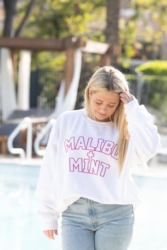 Introducing our Malibu and Mint Sweatshirt, a perfect blend of comfort and coastal vibes for those who embrace the sun, sand, and sea. Crafted with soft, breathable fabric, this sweatshirt is your go-to companion for breezy beach days or cozy evenings by the bonfire. The design captures the essence of pure joy with playful and vibrant hues that reflect the cheerful spirit of beach life. Embrace the sunshine in style and spread positive vibes with this Malibu and Mint Sweatshirt – where comfort meets the carefree allure of the ocean. *For an oversized fit, size up 1-2 sizes* **Washing Instructions: For best results, wash garment inside out in cold water. Avoid hot water to preserve fabric quality. Hang to dry to maintain shape and color vibrancy. Do not tumble dry or bleach. White Casual Sweats With Graphic Print, Casual White Sweats With Graphic Print, Casual White Graphic Print Sweats, Trendy White Sweats For Leisure, Casual White Sweats For Leisure, Summer Crew Neck Athleisure Sweatshirt, Summer Athleisure Sweatshirt With Crew Neck, Summer Athleisure Crew Neck Sweatshirt, White Comfortable Sweatshirt For Loungewear