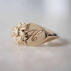 This vintage-inspired floral ring is a row of dainty flowers wrapped around your fingers. Handmade and polished, it is available in solid 8K and 14K gold. This item is engravable with text or monogram of your choice at no extra cost. The initals are engraved onto the ring and embedded in the 3D model for a flawless embossed finish. It is also possible to add a diamond or birthstone or diamond to this ring at an additional fee. Please inquire for details. A few notes about our gold: - Though we d Big Diamond Engagement Rings, Ring Size Chart, Couple Ring Design, Dainty Flowers, Diamond Signet Ring, Engraved Ring, Gold Monogram, Jewelry Lookbook, Small Rings