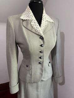 This 1940s WW2 era wool suit is fantastic.  The jacket has a pretty eyelet lace collar set into the tailored neckline.  All buttons are intact and there are faux pockets with coordinating buttons.  You simply cannot beat the flattery of a 40s ladies suit jacket.  The addition of the padded and tailored shoulder exaggerates the narrowness of the waist and the back view is all ways amazing as well - with this beautiful suit from Youthcraft there is a pretty A-line skirt that unfortunately was appealing to moths at some point in it's long life (see CONDITION).  The jacket is in near mint condition though and would look spectacular paired with skinny jeans and some high heels or boots.  CONDITION: Not gonna lie - the skirt is rough.  It has multiple moth holes and would need reweaving to be a Vintage Fitted Skirt Suit With Notch Lapel, Classic Fitted Skirt Suit With Button Closure, Classic Notch Lapel Skirt Suit With Buttons, Vintage Skirt Suit With Buttons For Office, Classic Skirt Suit With Notch Lapel, Vintage Office Skirt Suit With Buttons, Fitted Elegant Tweed Jacket With Buttons, Retro Formal Skirt Suit With Buttons, Vintage Tweed Jacket With Lapel Collar For Office