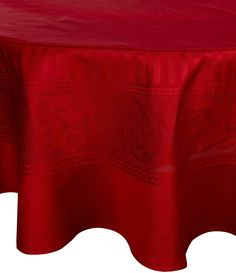 a red table cloth with an intricate design on the top and bottom, set against a white background