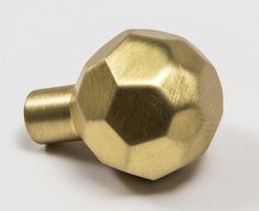 a close up of a metal knob on a white surface