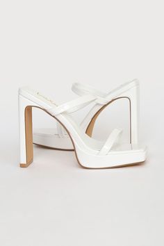 Who wouldn't be completely obsessed with the Lulus Fausee White Patent Square Toe Platform Slide Sandals! Sleek patent faux leather shapes these heels with a trendy square footbed (with a 0.5"" toe platform), a slender toe strap, and a matching vamp strap with a bit of elastic at the side. An easy-to-slide-on design tops a sky-high blade heel for a chic look! 4. 5" wrapped heel. Cushioned insole. Rubber sole has nonskid markings. Man made materials. Imported. Lulus | Fausee White Patent Square T Platform Slide Sandals, White High Heels, Square Toe Sandals, Patent Heels, Platform Slides, Sky High, Slide Sandals, Wedding Shop, Wedding Shoes