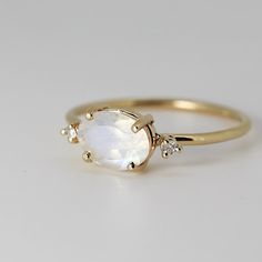 Luxury Oval Yellow Gold Moonstone Ring, Fine Jewelry Oval Moonstone Ring With Rose Cut Diamonds, Heirloom Oval Moonstone Jewelry, Delicate Oval Moonstone Ring In 14k Gold, White Oval Cabochon Moonstone Ring In 14k Gold, 14k Gold White Moonstone Oval Cabochon Ring, Elegant 14k Gold Moon Shaped Ring, White Moonstone Oval Cabochon Ring In 14k Gold, Yellow Gold Oval Moonstone Ring