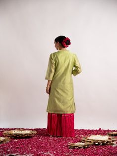 Pista green silk chanderi straight kurta detailed with beautiful gotta pati hand work, has a mandarin collar, three-quarter sleeves, Rani cotton wrinkled sharara with gotta line. This kurta sharara comes with wrinkled rani dupatta with tassels. Fabric: Chanderi Silk & Wrinkled Cotton Color: Pistachio green and hot pink Note: Wash Care Instruction - Dry Clean Only The product will be shipped within 15-20 days of order placed Size Chart: Kurta Size XS S M L XL XXL XXXL Bust 36 38 40 42 44 46 Waist Festive Embroidered Kurta With 3/4 Sleeves, Festive 3/4 Sleeve Embroidered Kurta, Festive Kurta With 3/4 Sleeve For Eid, Festive 3/4 Sleeve Kurta For Eid, Festive Kurta With 3/4 Sleeves, Cotton Long Sleeve Kurta With Gota Work, Long Sleeve Cotton Kurta With Gota Work, Festive Pista Green Chanderi Kurta, Green Straight Kurta With Resham Embroidery