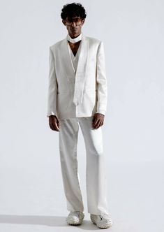 Elevate your style with our alabaster blazer. This classic straight-cut blazer, crafted from high-quality white vegan mashru fabric, is a testament to timeless sophistication and remarkable comfort. The blazer showcases an asymmetrical shawl collar with tie-shaped ends, adding a unique touch of refinement to your ensemble. Modern White Single Button Blazer, White Structured Single-button Blazer, Modern White Blazer With Hidden Button Closure, Chic White Outerwear With Pressed Crease, Modern White Office Blazer, Modern White Blazer With Suit Collar, Modern White Blazer, White Structured Blazer For Formal Occasions, White Structured Blazer With Hidden Button Closure