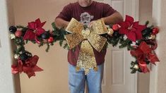 a man standing in front of a doorway with christmas decorations