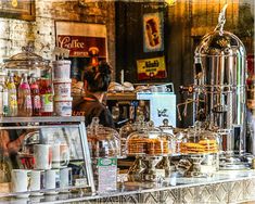 there are many different items on the counter in this store that is selling coffee and pastries