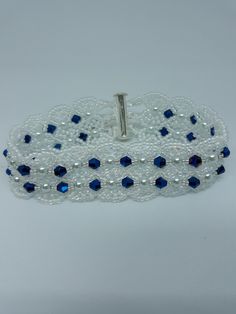 This handmade beautiful bracelet is made of quality materials. It measures 7 1/2 inches, and has a silver slide bar clasp. If you like high fashion you will love this one. Made with navy blue crystals, white pearls, white iridescent seed beads, jewelry line. Elegant Adjustable Blue Crystal Bracelet, Elegant Beaded Bangle Crystal Bracelet, Elegant Adjustable Crystal Bracelet With Silver Beads, Elegant Adjustable Beaded Bracelet With Silver Beads, Elegant Beaded Crystal Bangle Bracelet, Handmade Silver Wristband As Gift, Elegant Adjustable Blue Bracelets, Elegant Adjustable Blue Beaded Bracelets, Elegant Adjustable Silver Beaded Bracelets