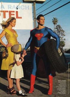 a man and woman dressed up as superman and a girl in a yellow dress are standing next to each other