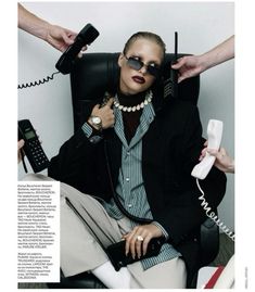 a woman sitting in a chair while talking on the phone