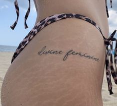 “divine feminine” tattoo in black color. this tattoo located on the buttock. it is look so amazing i advice to do such tattoo Baddie Quotes Tattoo, Mac Miller Nails Ideas, Love Inspired Tattoos, Tattoo Ideas Mac Miller, Handle With Care Tattoo, French Tattoo Ideas, Mac Miller Aesthetic, Self Care Tattoo, Pure Tattoo