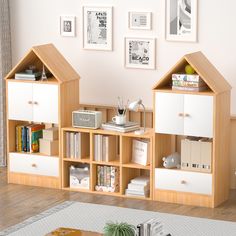 a living room with some bookshelves and pictures on the wall behind it,