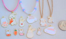 "Bunny Rabbit, Carrot And Paw Print Enameled For Easter Necklaces With Drop Charm Pendants White Pink Gold. You have many options to choose from for the necklace. I will custom make them for you with your desired style, color and length or you can choose from one of the photographed styles. I have gold chains, suede cord, and beaded necklaces. All have a lobster claw clasp closure. The standard length is 18\" for all of the necklaces. If you would like a different length just send me a message when ordering. I can also add a 2\" extension chain if needed for to allow you some flexibility in fit. You pick the color of your necklace!! These would make a beautiful present for any time of the year.   I also have a nice selection of suede cords and make my own necklaces so if you would like a d Cute White Nickel-free Necklaces, Cute White Nickel Free Necklaces, Cute White Nickel-free Charm Necklaces, Cute Enamel Necklaces For Gifts, White Novelty Enamel Jewelry, White Enamel Novelty Jewelry, Easter Necklace, Easter Jewelry, Rosa Gold