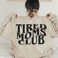 beige unisex tired moms club sweatshirt with print on the back Trendy Winter Sweater For Lounging, Cozy Long Sleeve Tops For Weekend, Cozy Long Sleeve Weekend Tops, Comfy Super Soft Sweatshirt For Lounging, Trendy Cotton Sweatshirt For Lounging, Comfy Super Soft Lounging Sweatshirt, Trendy Cotton Lounging Sweatshirt, Super Soft Sweatshirt For Fall Lounging, Super Soft Cozy Fit Sweatshirt For Lounging