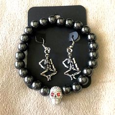 Halloween Skeleton Earrings & Bracelet Set. Full Body Skeleton Earrings With Matching Gun Metal Beaded Bracelet With Rhinestone Skull Head. Get Halloween Ready With This Spooky Set. Black Metal Bracelets For Halloween, Black Metal Bracelet For Halloween, Punk Stainless Steel Jewelry For Party, Punk Style Stainless Steel Jewelry For Party, Punk Style Stainless Steel Party Jewelry, Punk Alloy Jewelry For Halloween, Edgy Silver Alloy Jewelry, Gothic Bracelets For Halloween Gift, Gothic Halloween Bracelets As A Gift