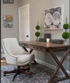 a white chair sitting in front of a wooden desk on top of a blue rug