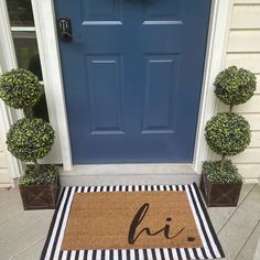 a door mat with the word hi written on it in front of a blue door