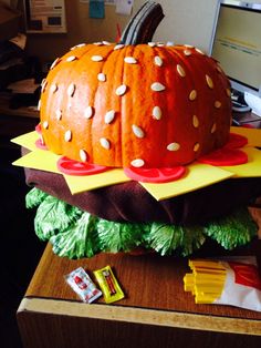 a giant hamburger cake sitting on top of a desk