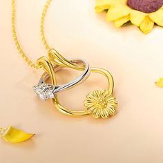 This is a beautiful and practical necklace that allows you to keep your ring safe and close to your heart. The sterling silver ring holder features a delicate sunflower design that symbolizes happiness, loyalty, and love. The necklace is perfect for anyone who needs to take off their ring for work, sports, or other activities, or who simply wants to wear their ring in a different way. The necklace comes with a  sterling silver chain and a lobster clasp. The ring holder can accommodate most ring Anniversary Jewelry Ring With Flower Charm, Yellow Flower Jewelry For Anniversary, Yellow Flower Shaped Jewelry For Anniversary, Yellow Flower-shaped Jewelry For Anniversary, Wedding Jewelry With Sunflower Design, Anniversary Gold Jewelry With Sunflower Design, Sunflower Design Jewelry For Anniversary, Sunflower Design Jewelry For Mother's Day, Sunflower Design Flower Jewelry For Anniversary