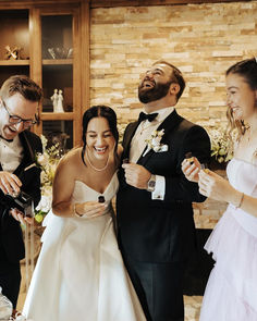 a bride and groom standing next to each other in front of their guests at a wedding